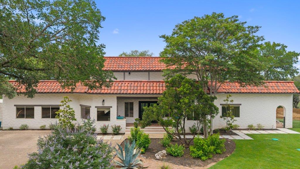 Mediterranean-style exterior featuring a red tile