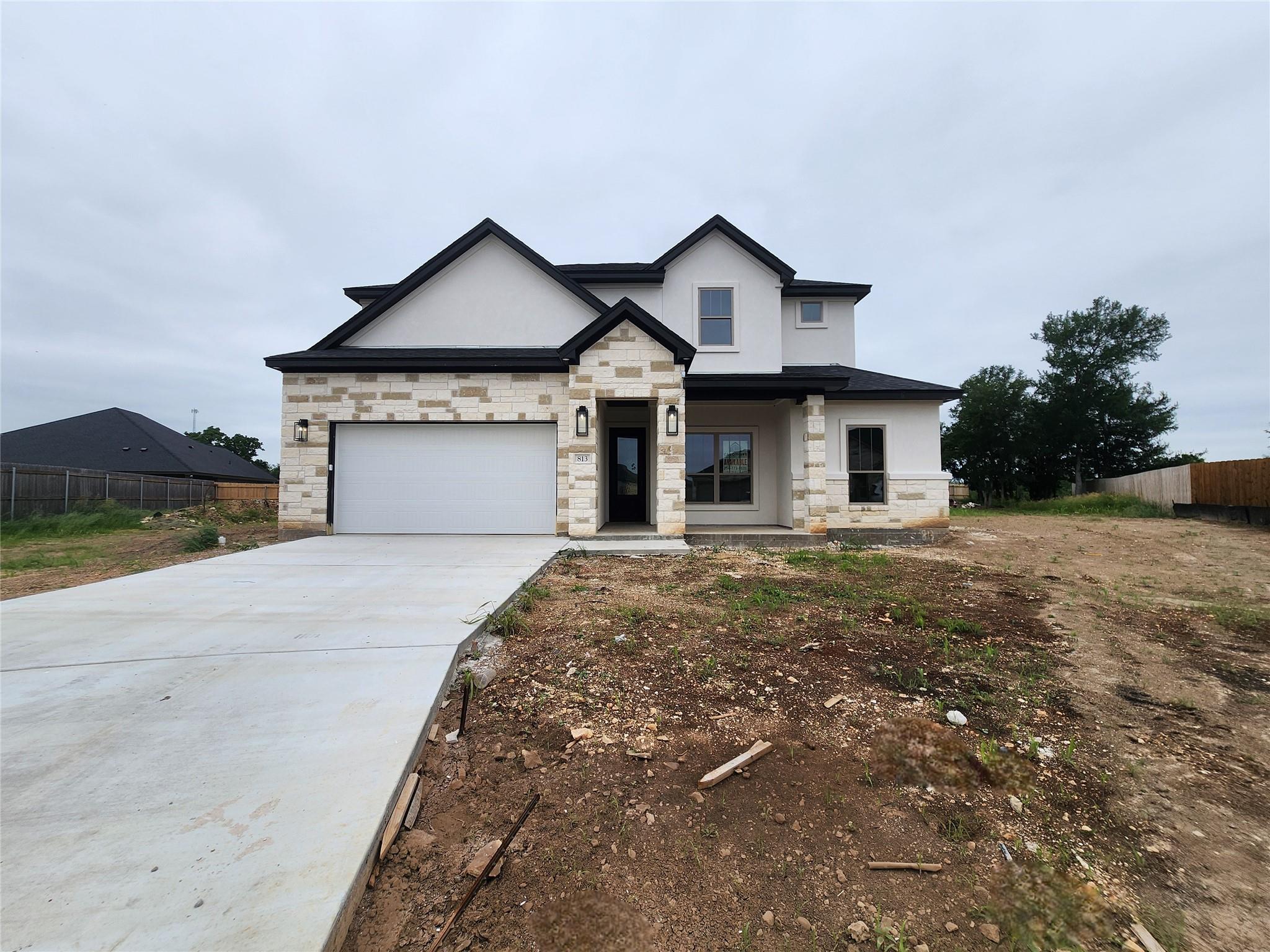 Two-story residence featuring a mixed material ex