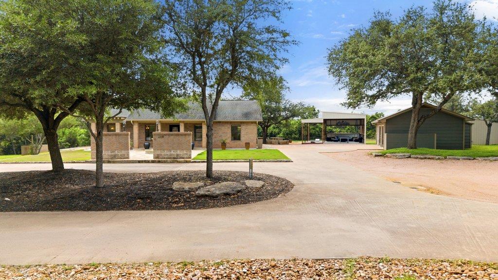 Brick residence featuring a stone-clad entry, mat