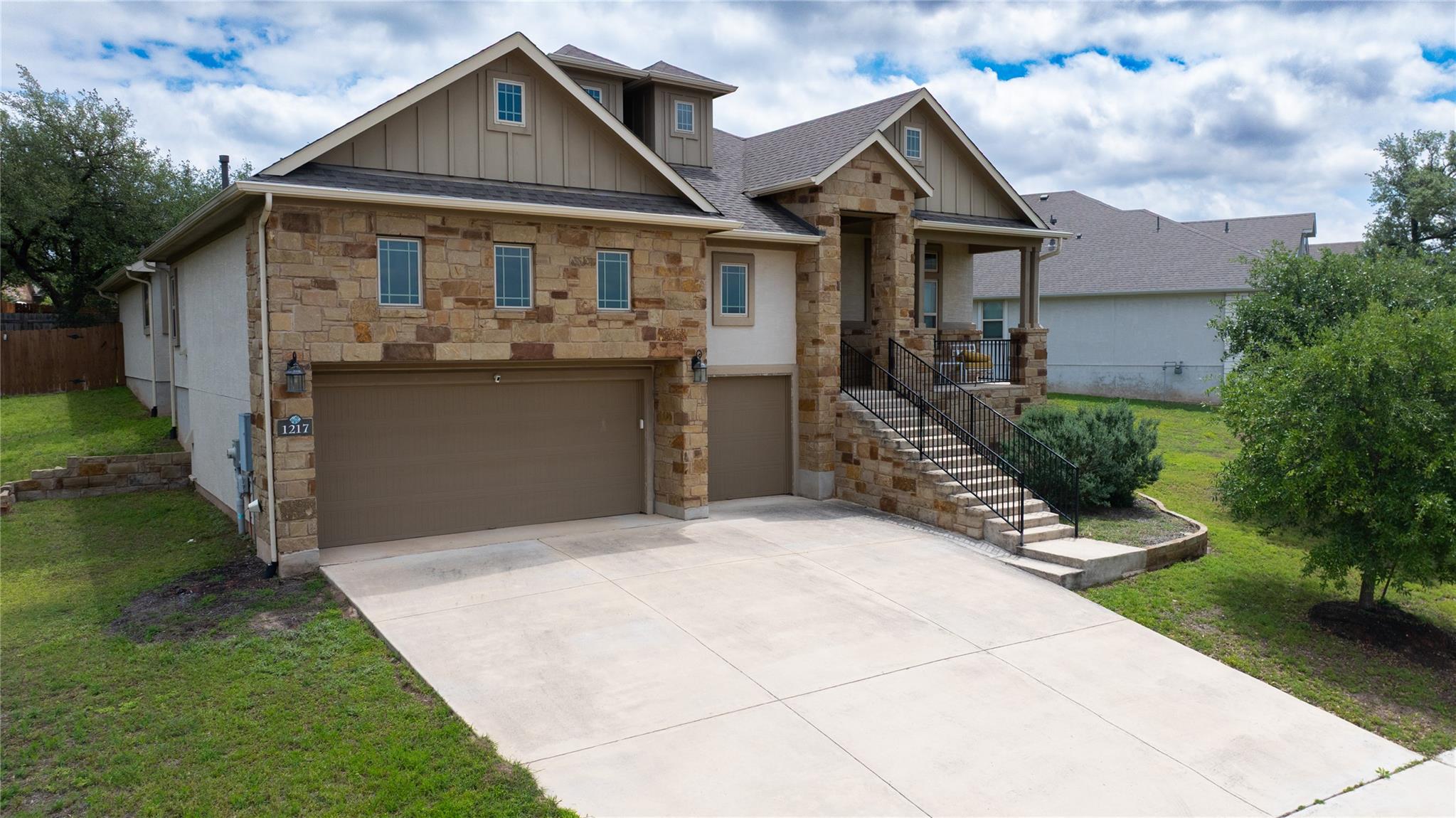 Stone and stucco exterior featuring multiple gabl