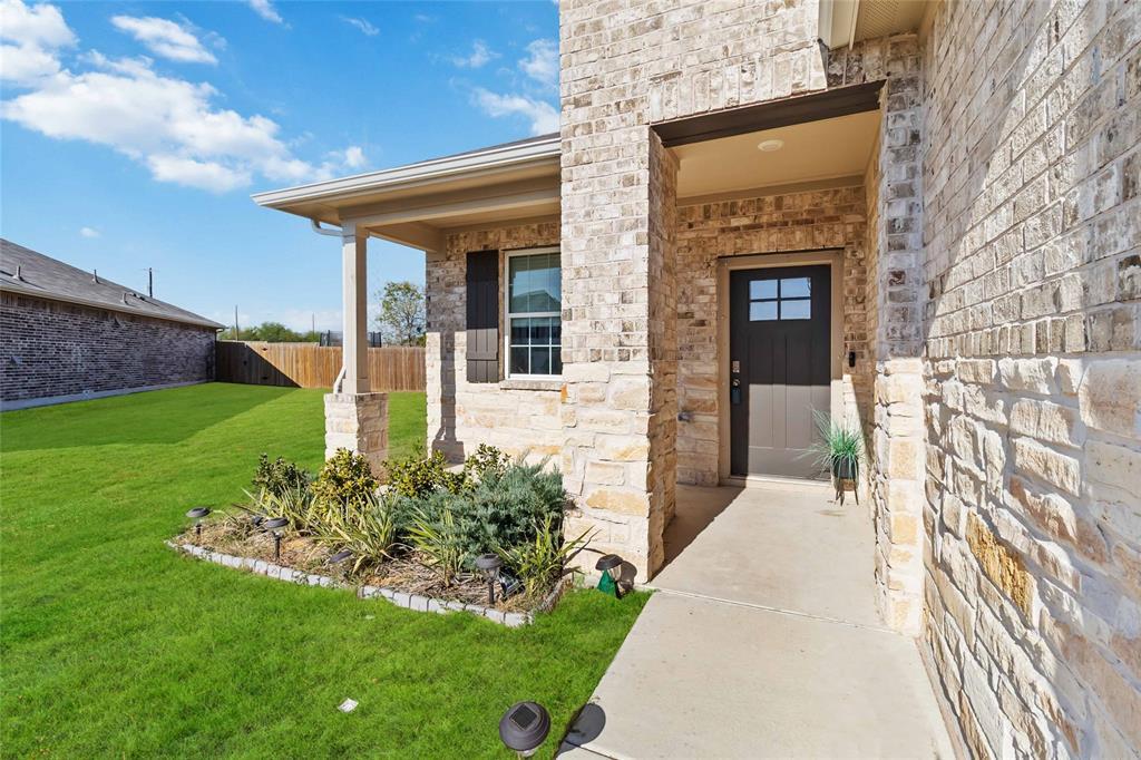 Stone and brick exterior with a covered entry
