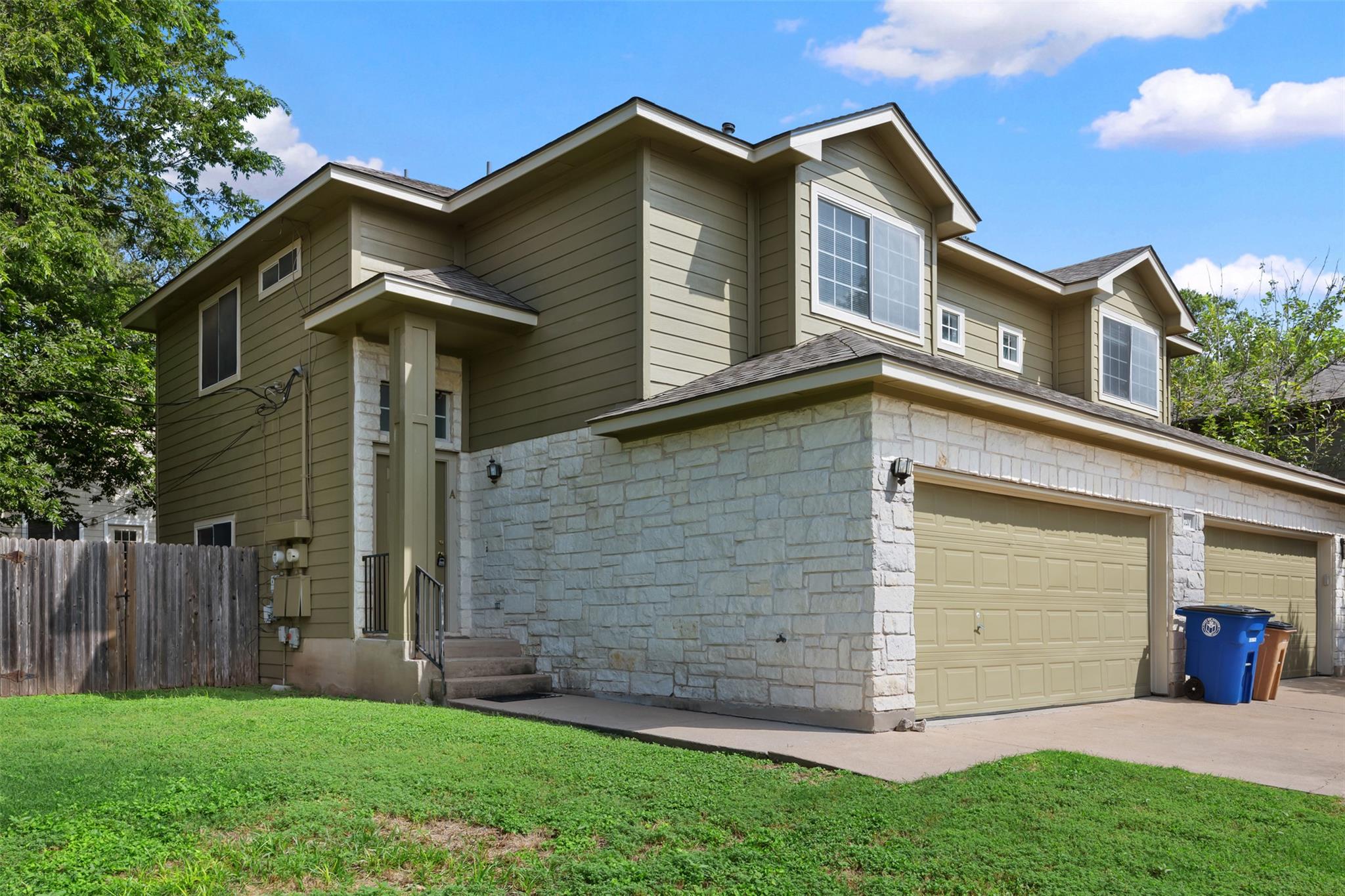 A handsome stone and siding facade offers excelle