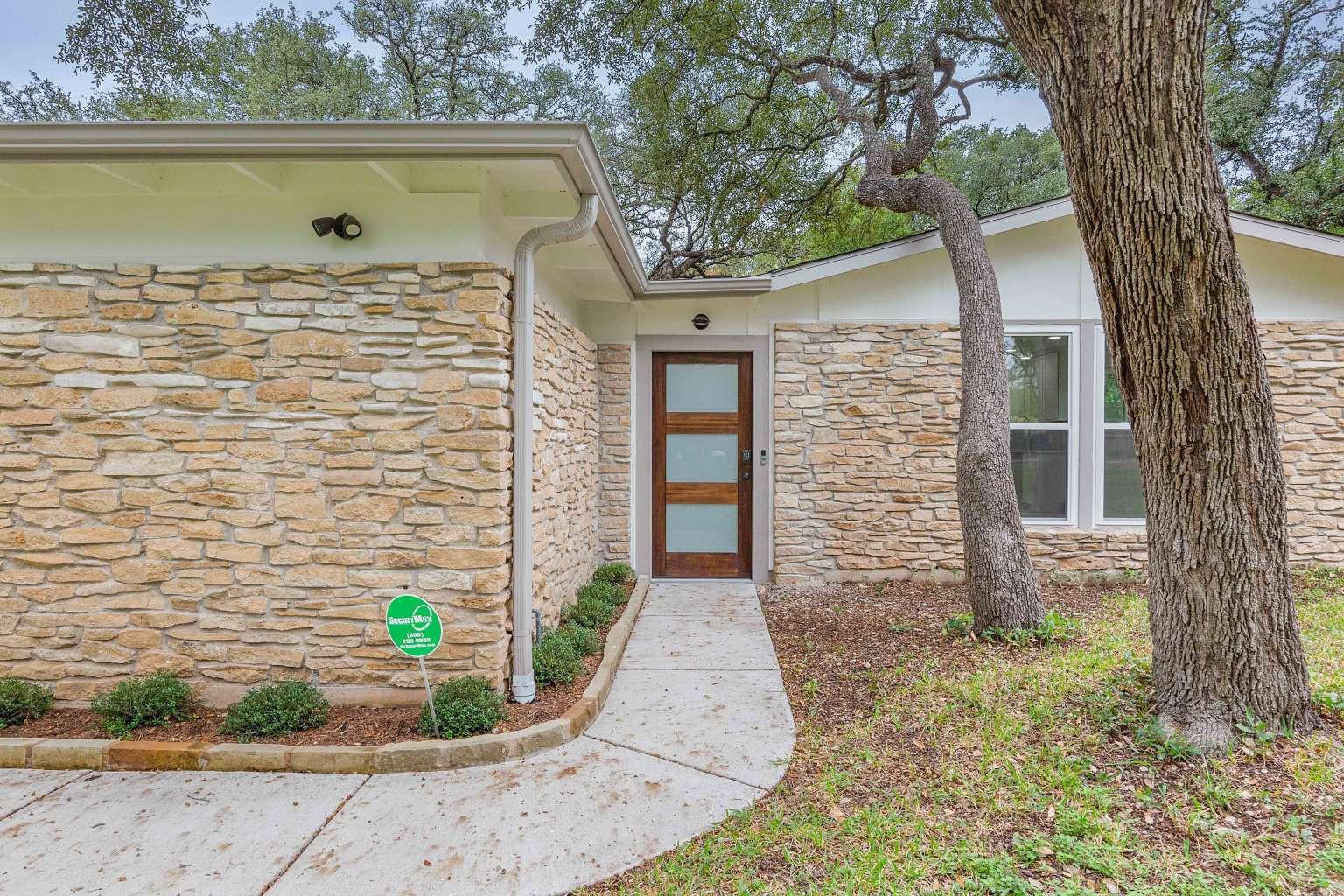 A graceful curved walkway leads to the contempora