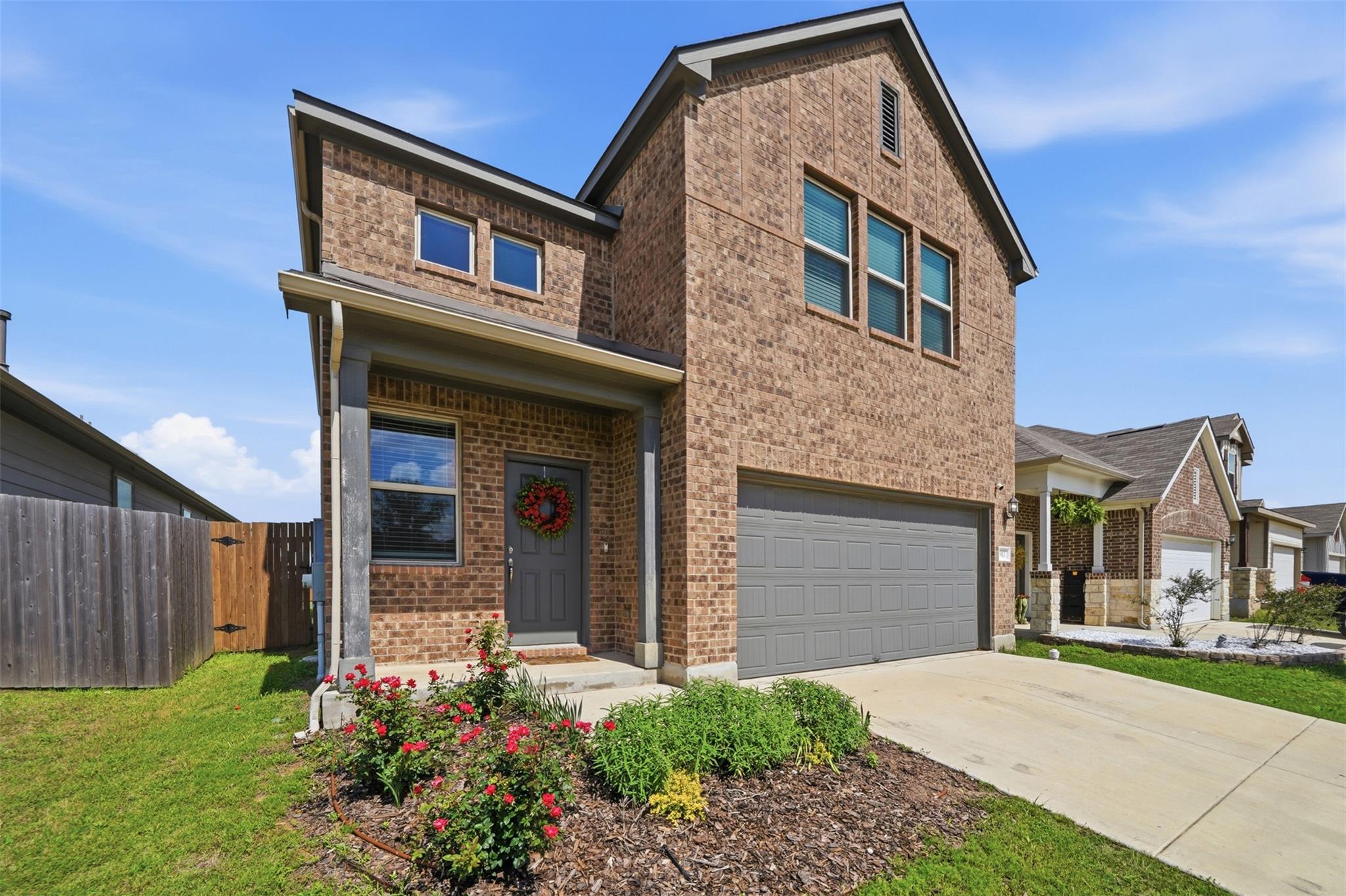 Two-story brick facade property featuring a cover
