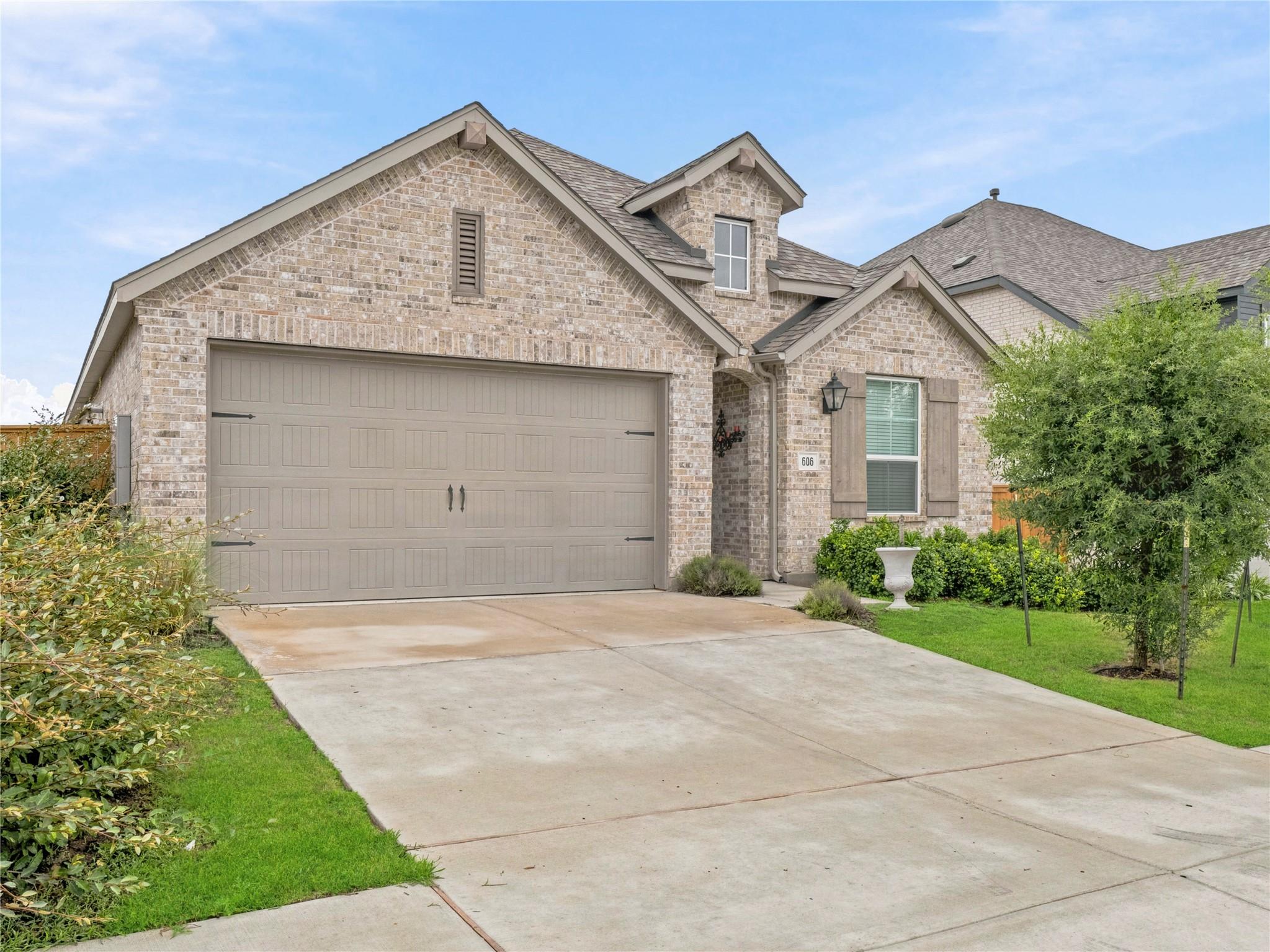 A well-maintained brick exterior and a paved driv