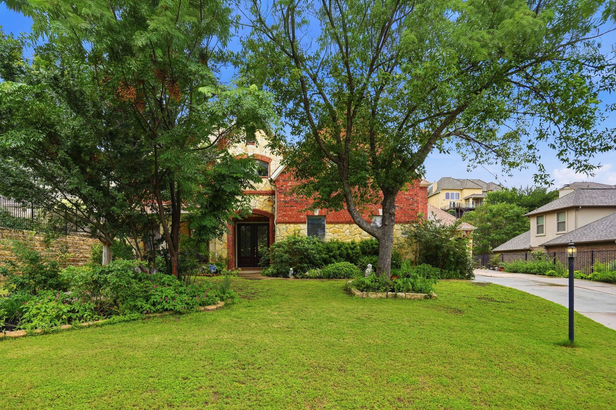 Stately residence featuring a red brick and stone