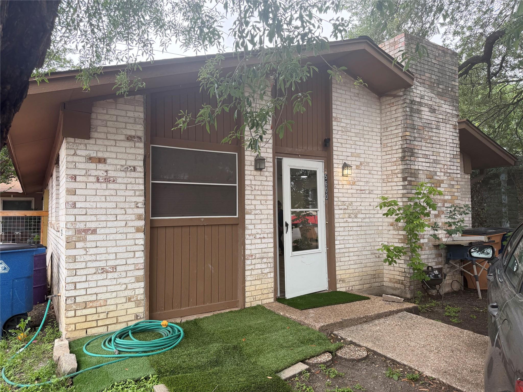 Exterior featuring light-colored brick siding and