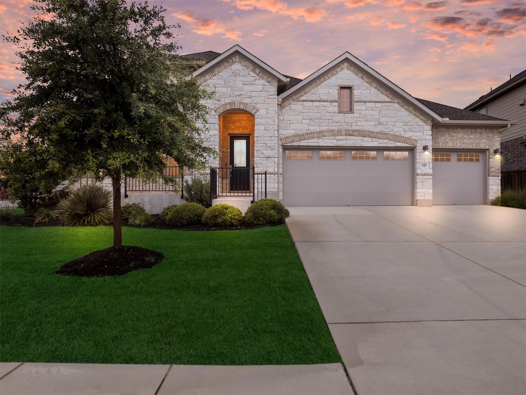 Stone facade residence with a two-car garage, an 