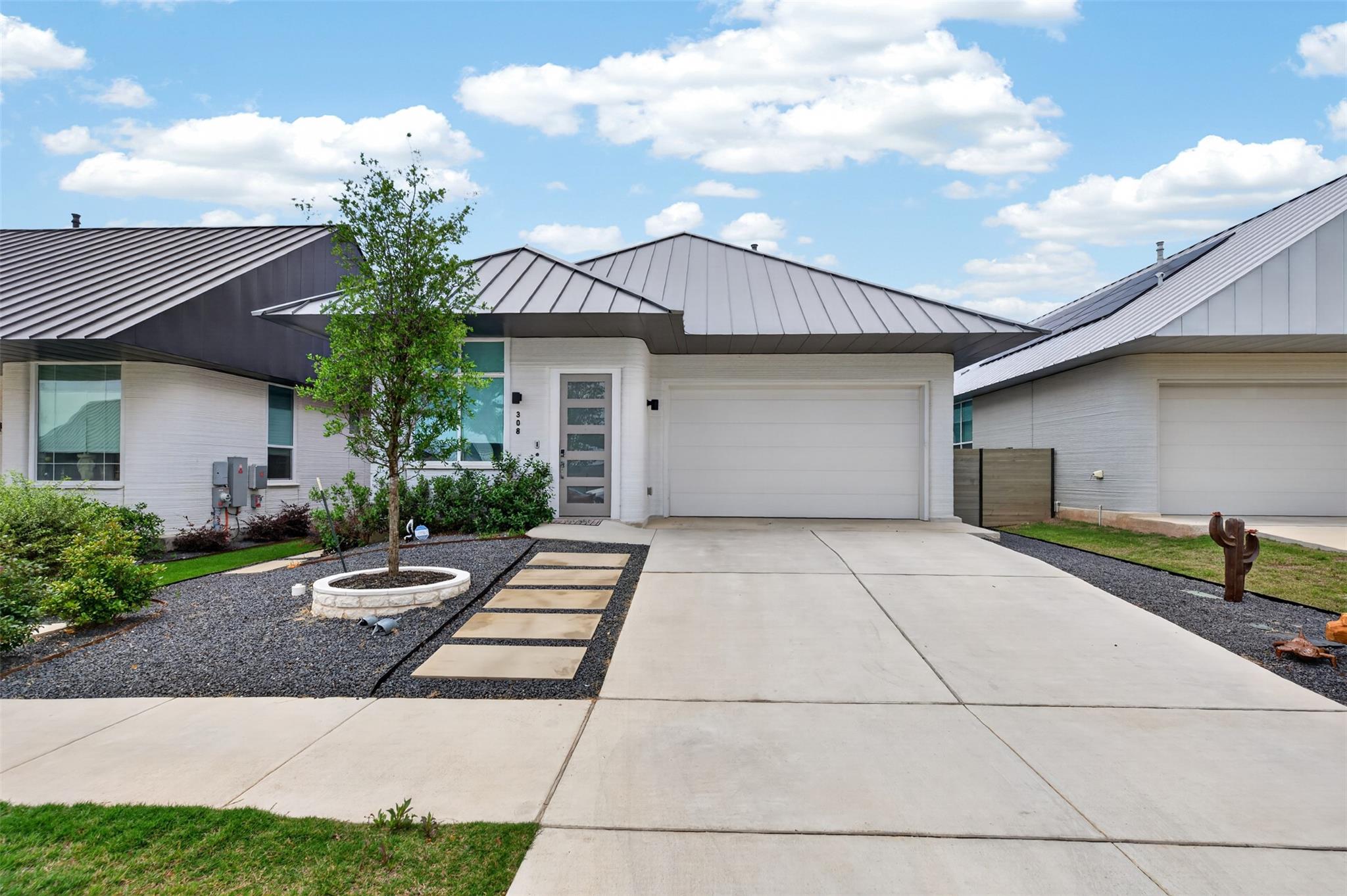 Modern white brick exterior with a gray metal roof