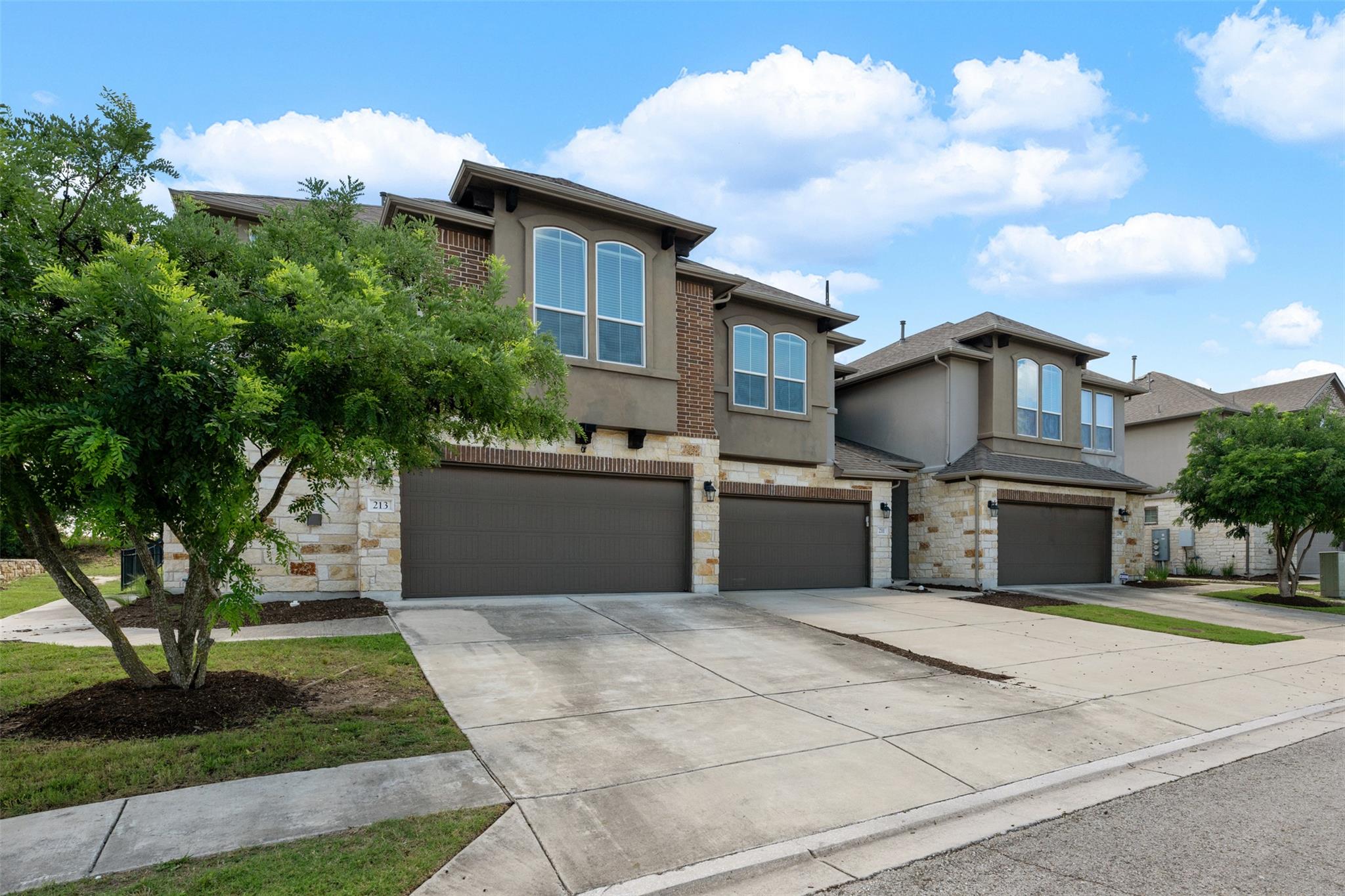 Modern townhome exterior featuring stone and stuc