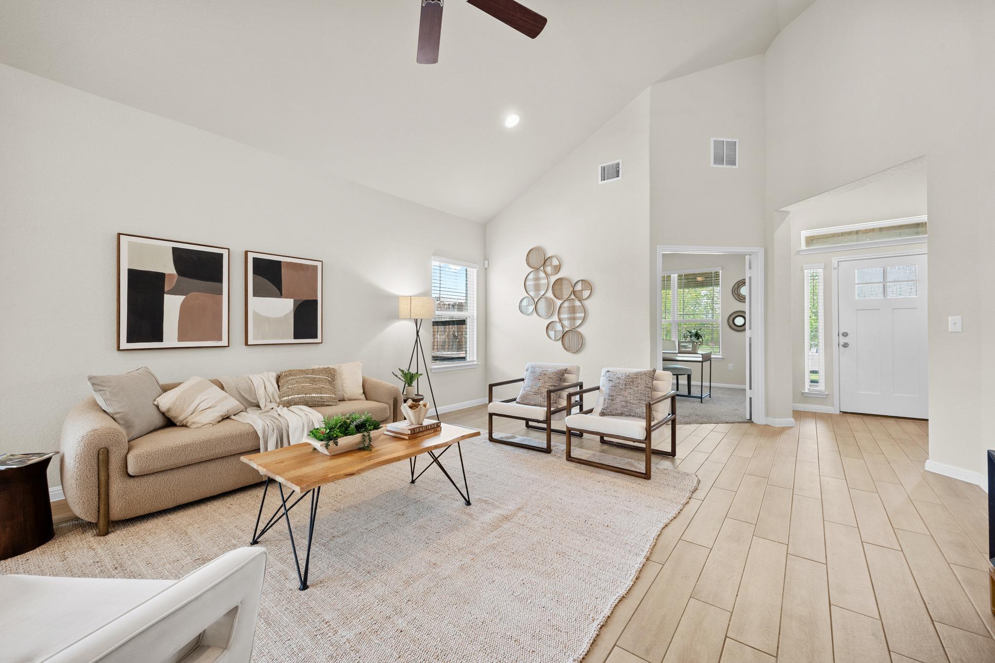 Vaulted ceilings accent a spacious living area fe