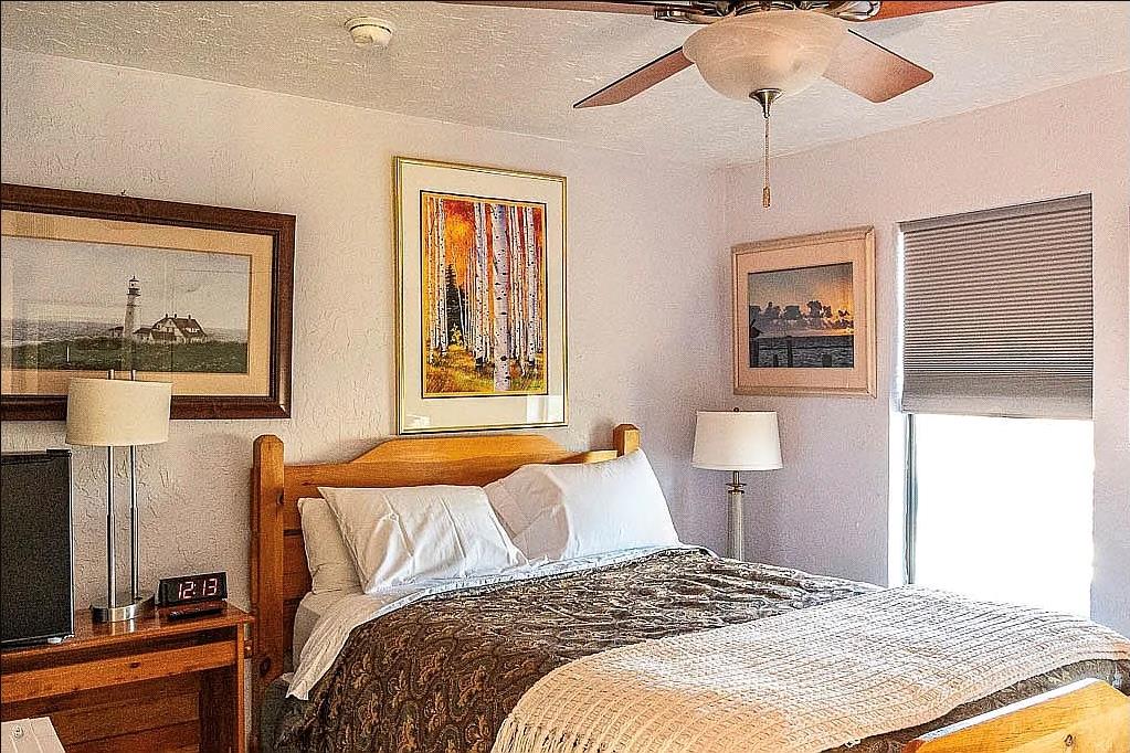 Bedroom featuring a ceiling fan with integrated l