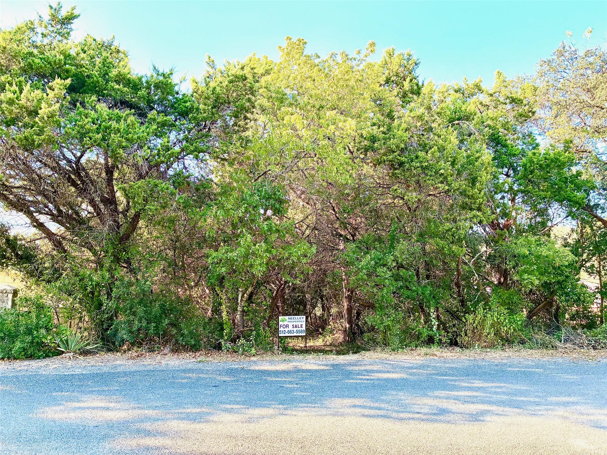 Tree-covered lot featuring natural landscaping an