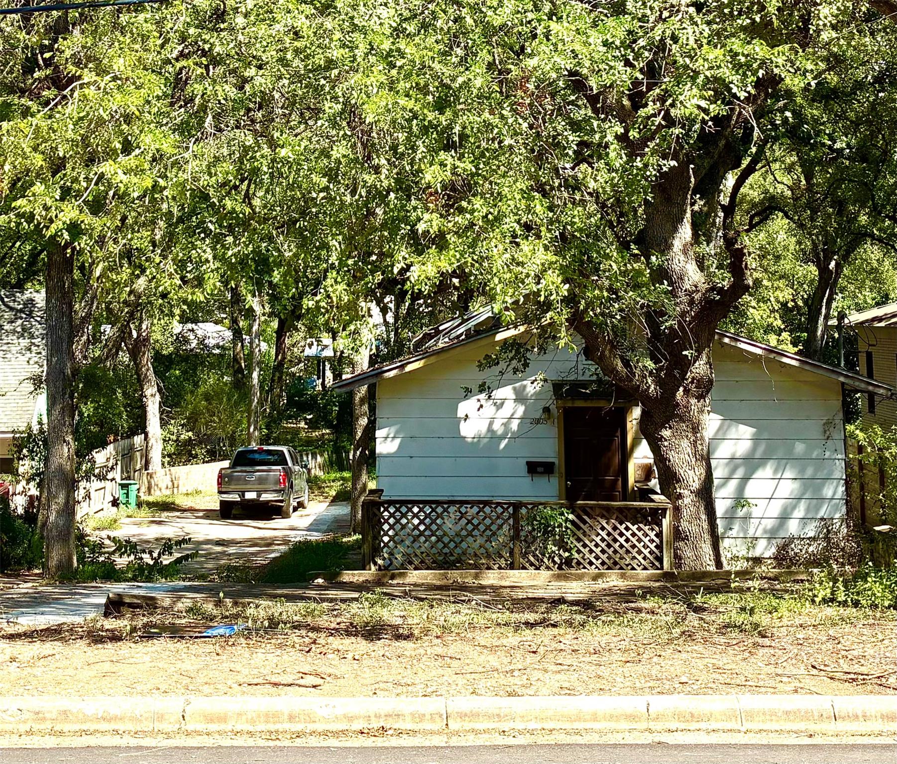 Single-story residence featuring white siding, a 