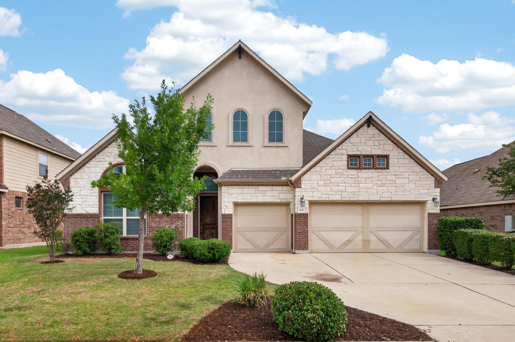 Two-story residence featuring a combination of br