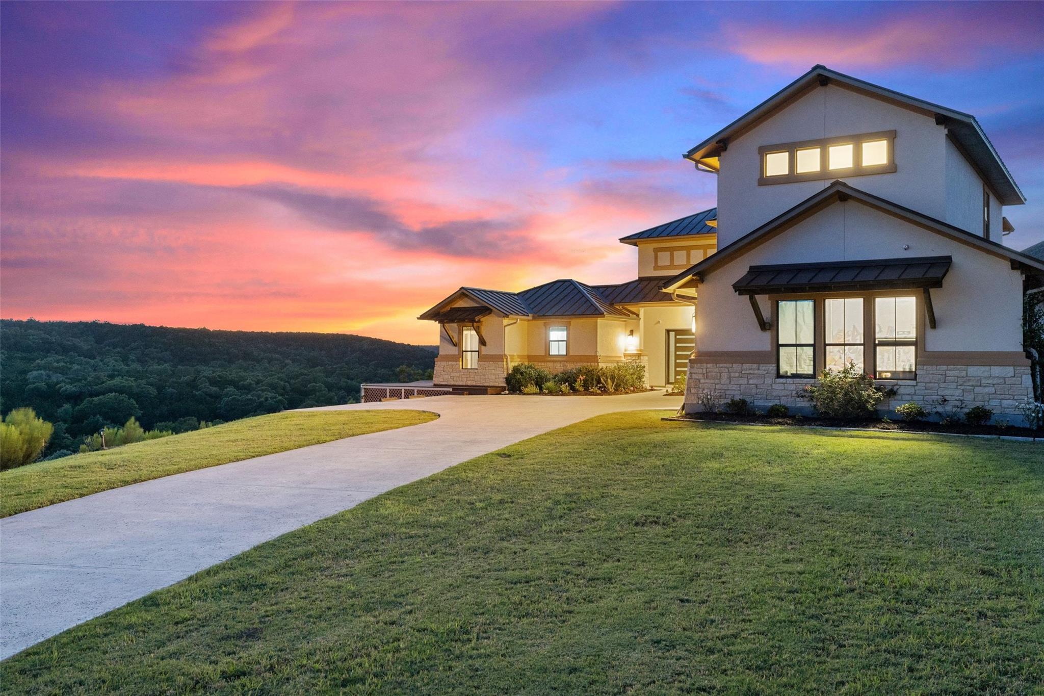 Dramatic sunset over this hill-country estate wit