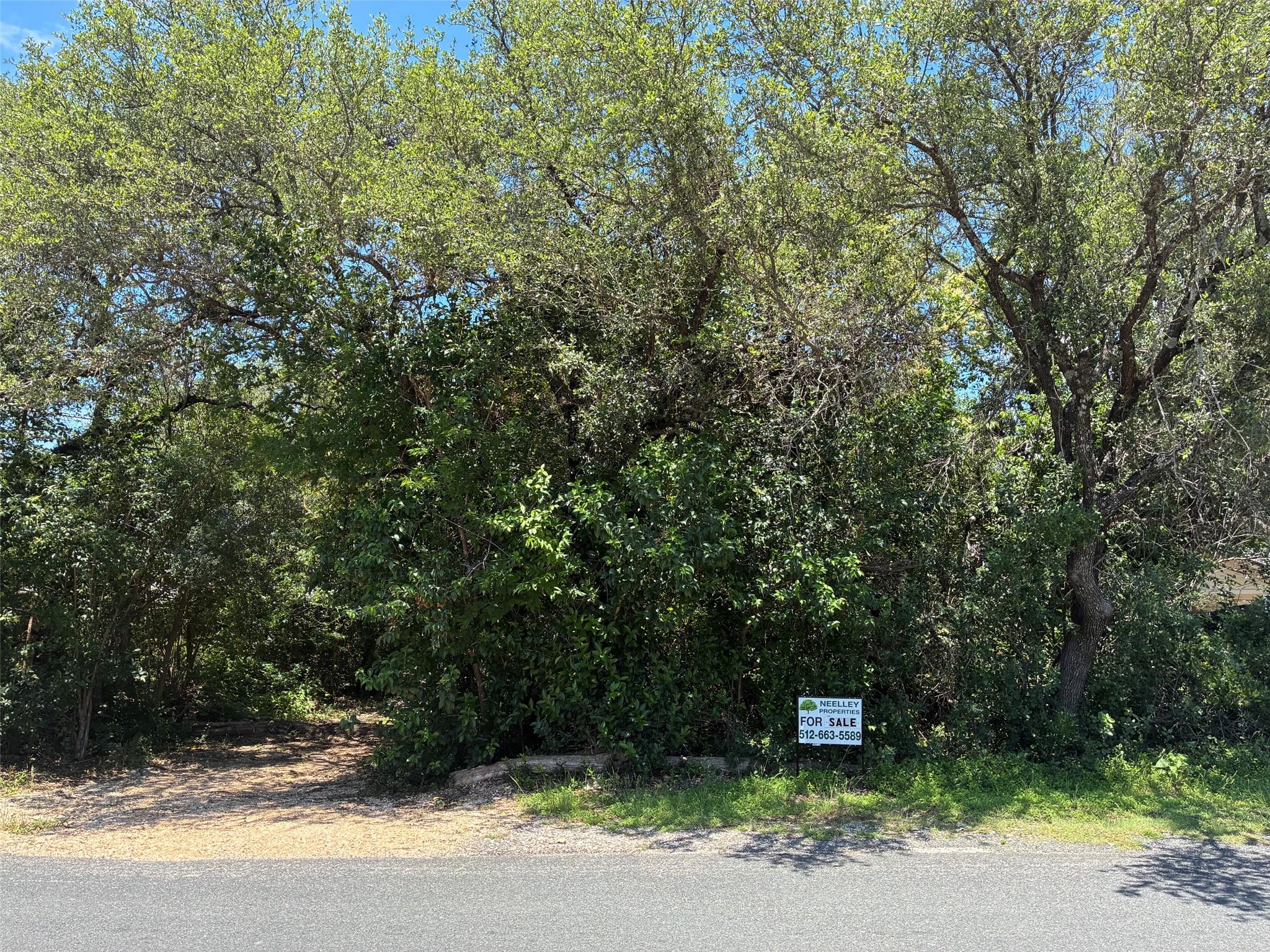 Heavily wooded lot featuring mature trees and den