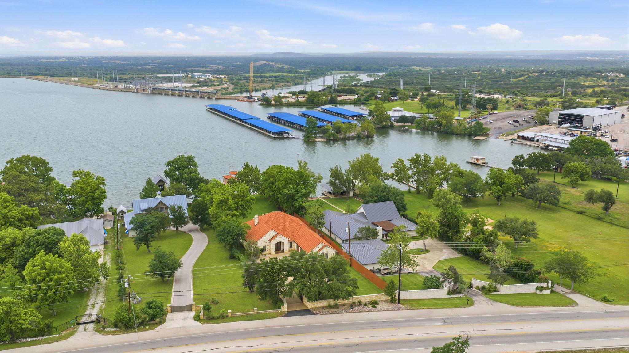 Waterfront property featuring a tile roof, stone 
