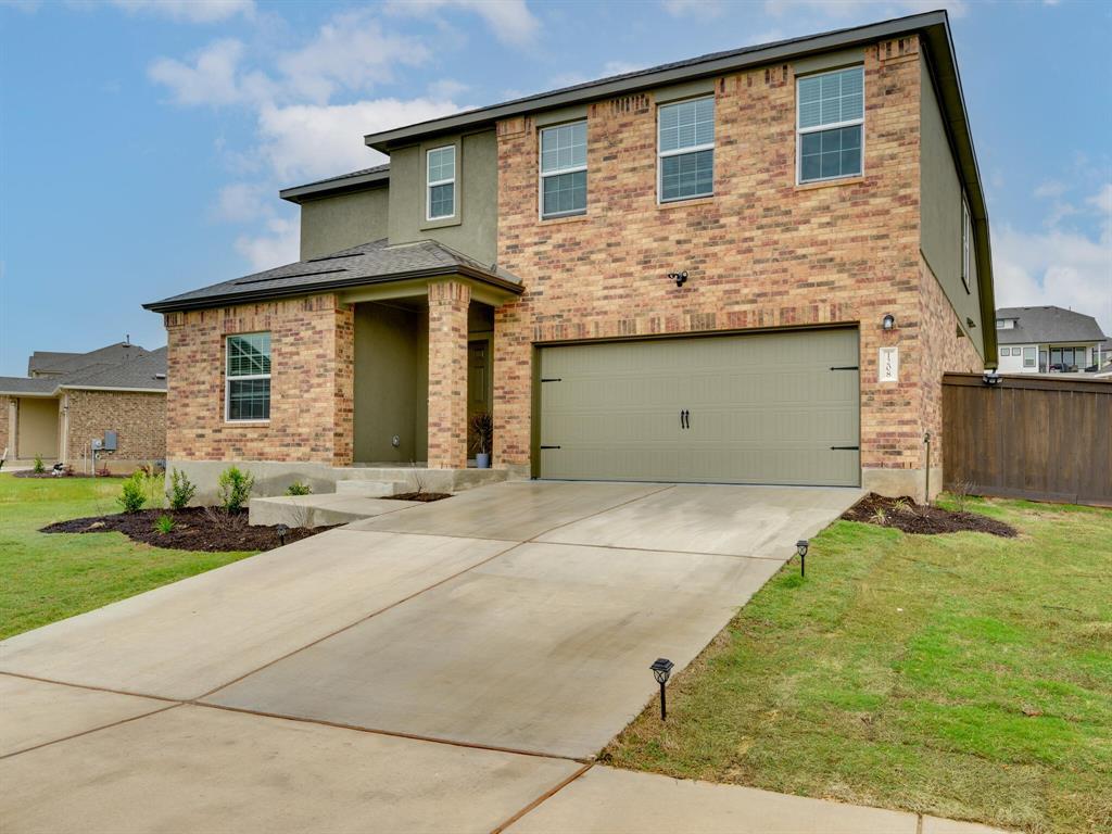 Contemporary two-story exterior featuring brick a