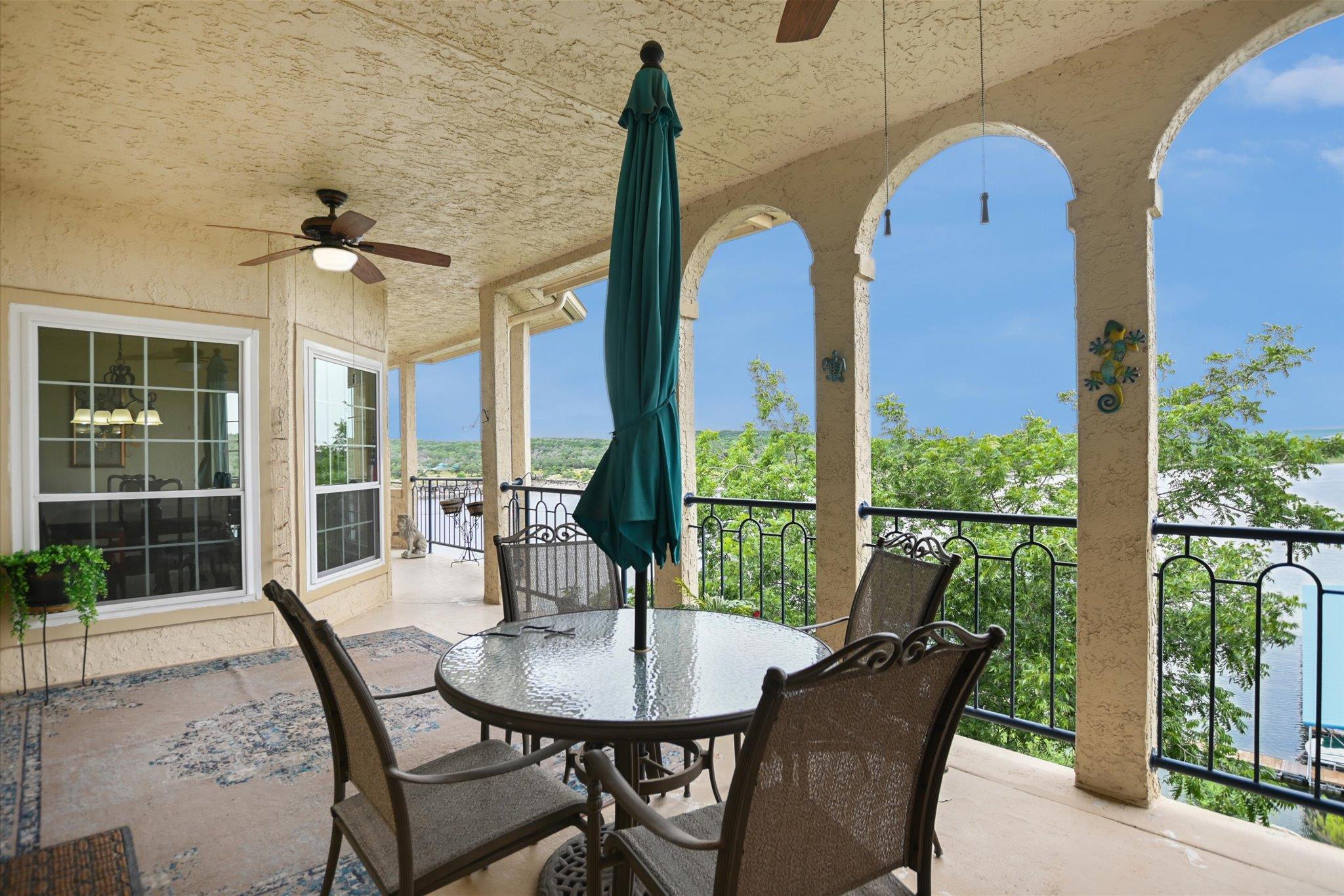 An inviting covered patio offers captivating lake