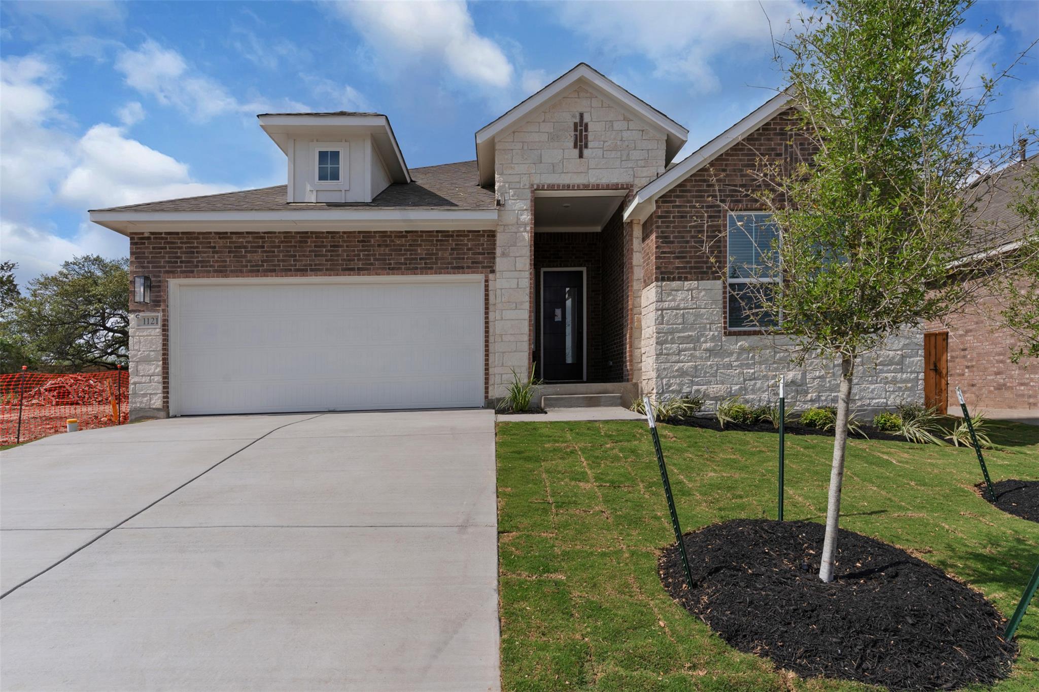Contemporary exterior featuring a brick and stone