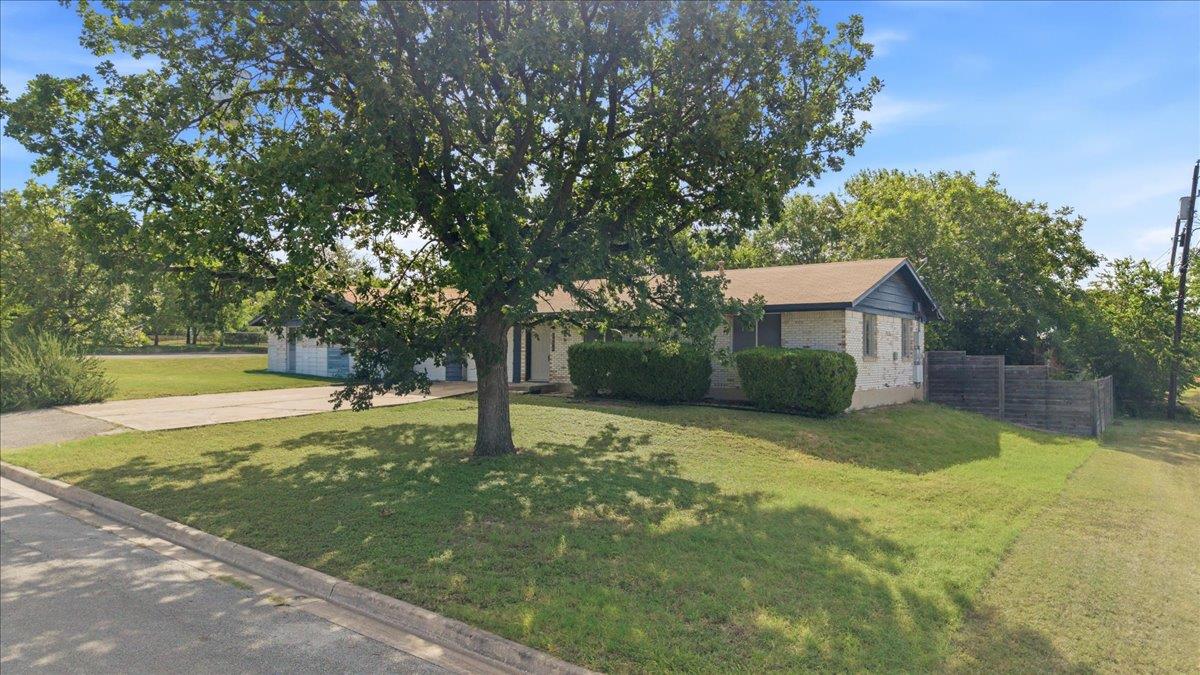 Mature trees and lush lawns enhance the exterior 