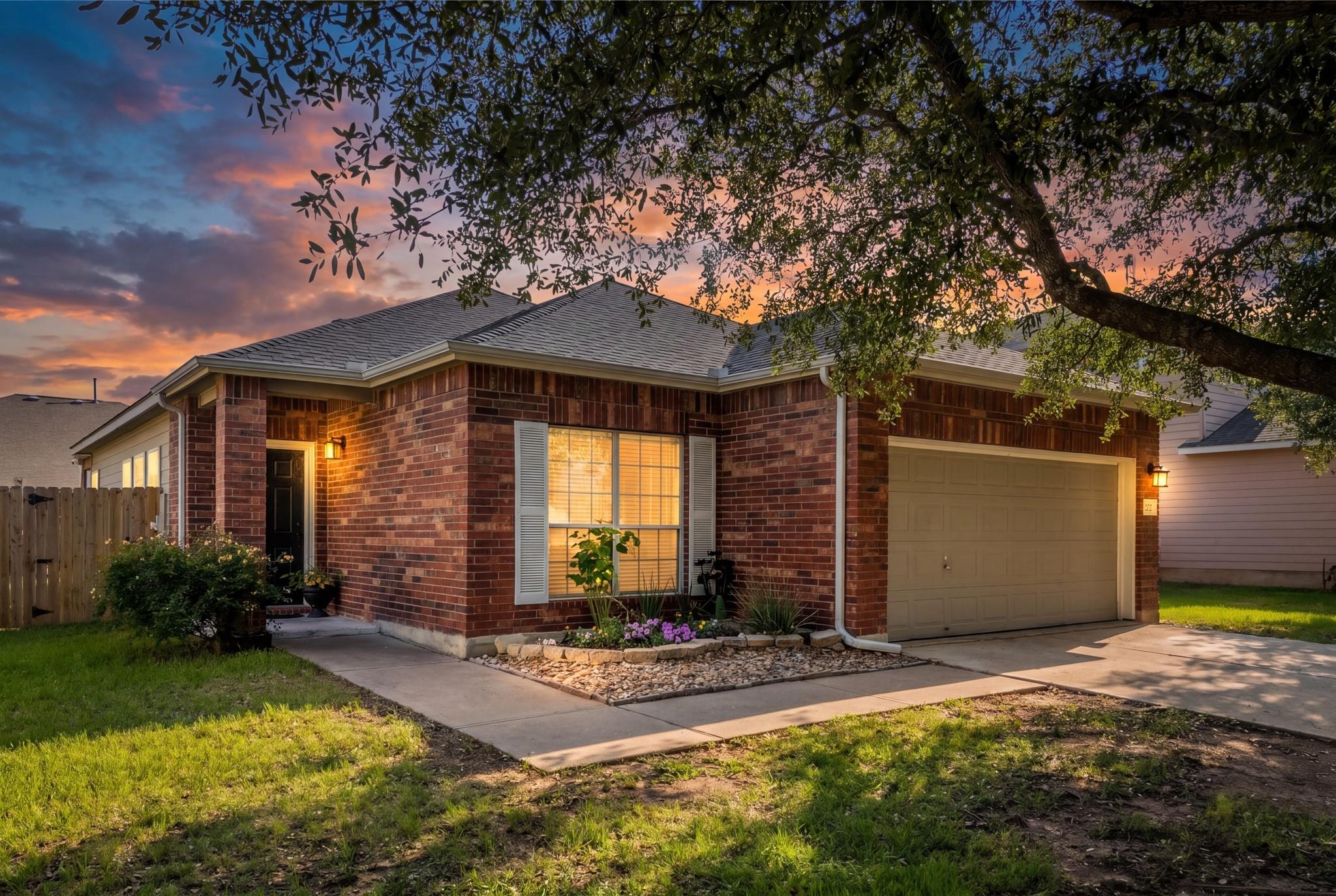 Brick exterior featuring a single-car garage, a c
