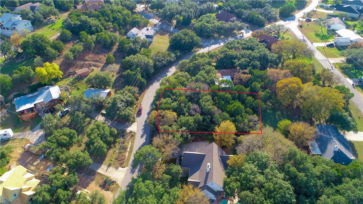 Wooded land parcel featuring mature trees, surrou