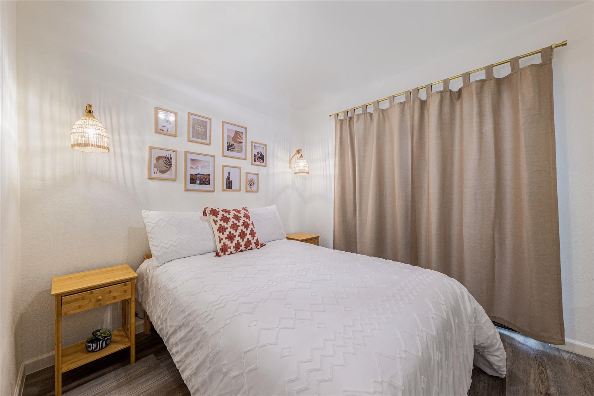 Bedroom featuring wood-finish flooring, two natur