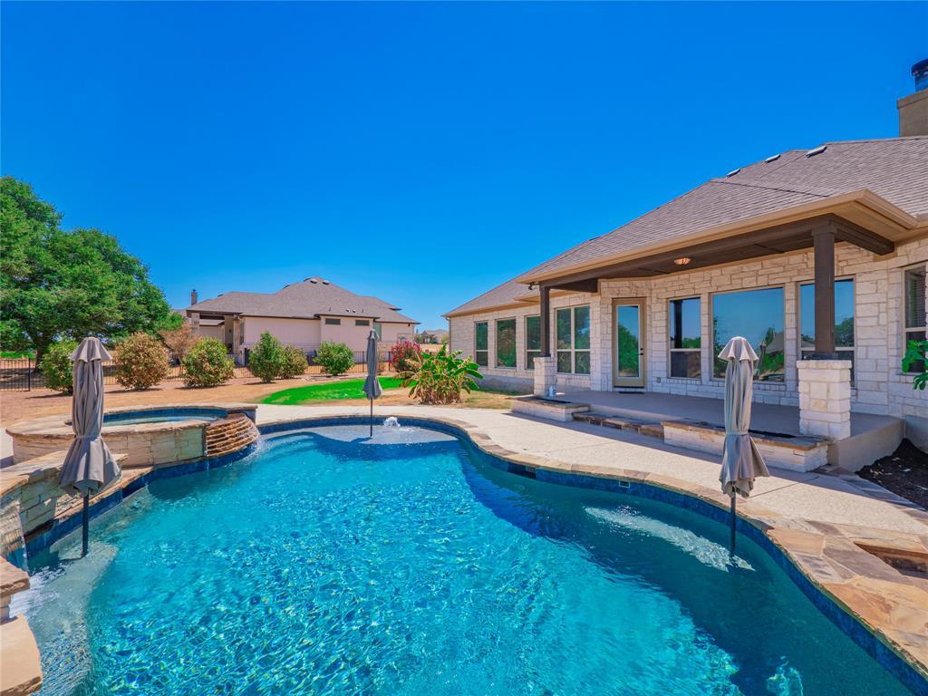 Swimming pool with integrated spa and waterfall f
