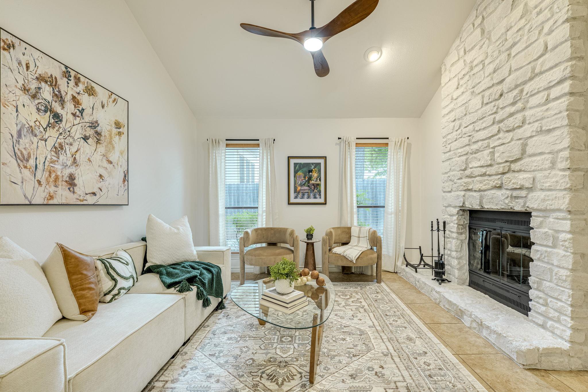 Living area featuring a vaulted ceiling with a mo