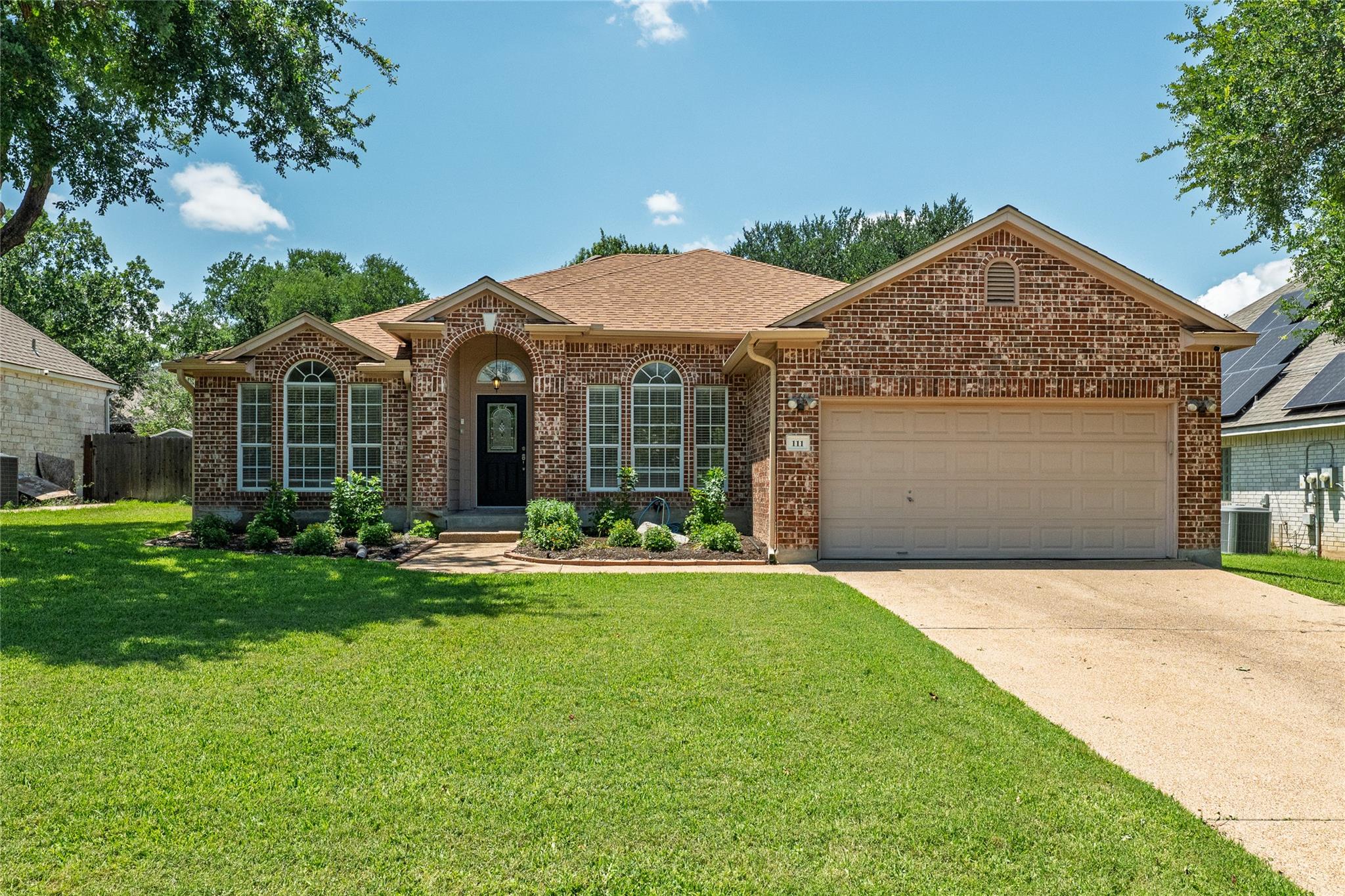 Brick exterior with a prominent arched entry, mul