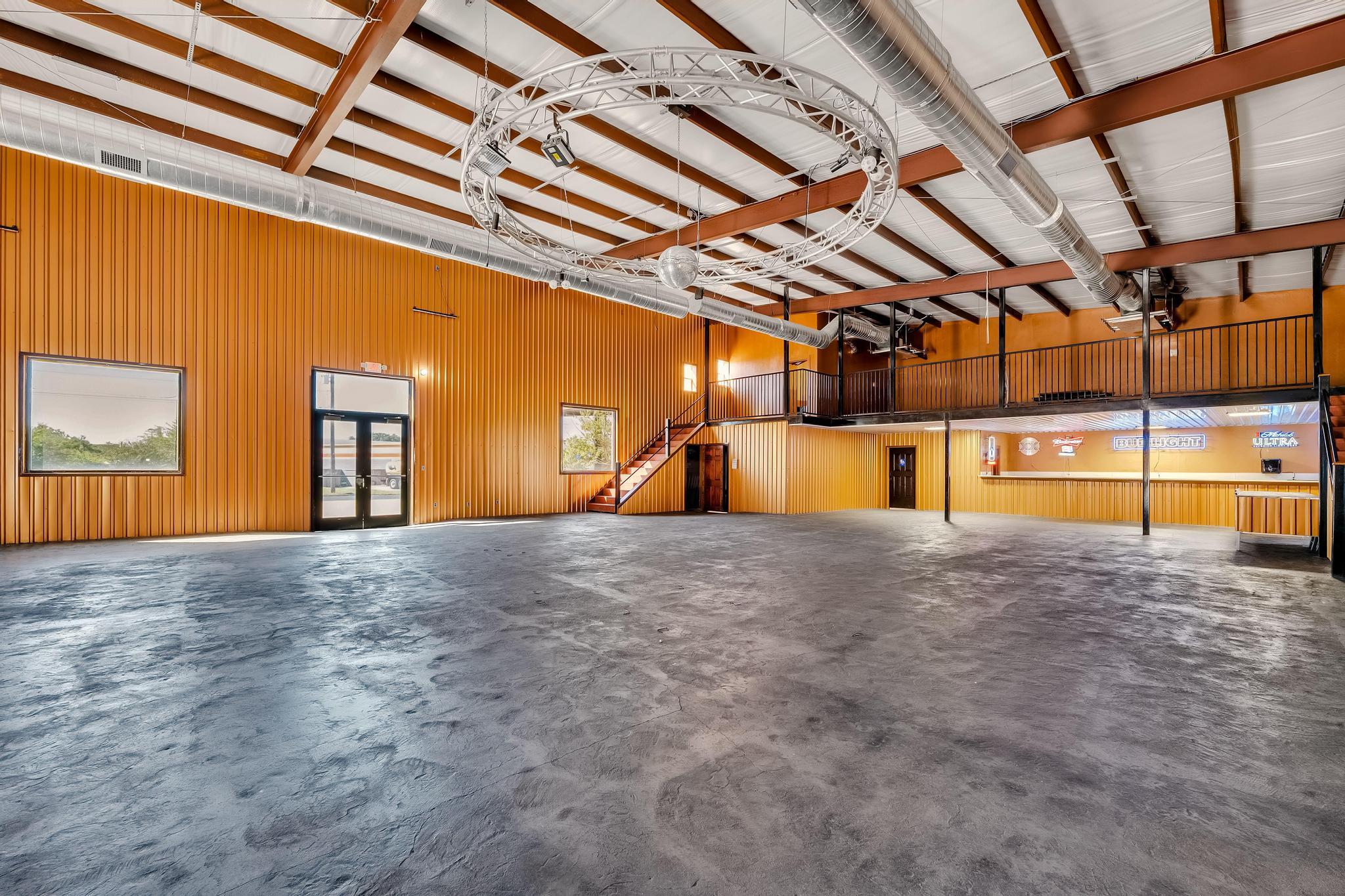 Spacious interior featuring high ceilings with ex