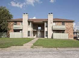 Brick exterior with a brown shingle roof