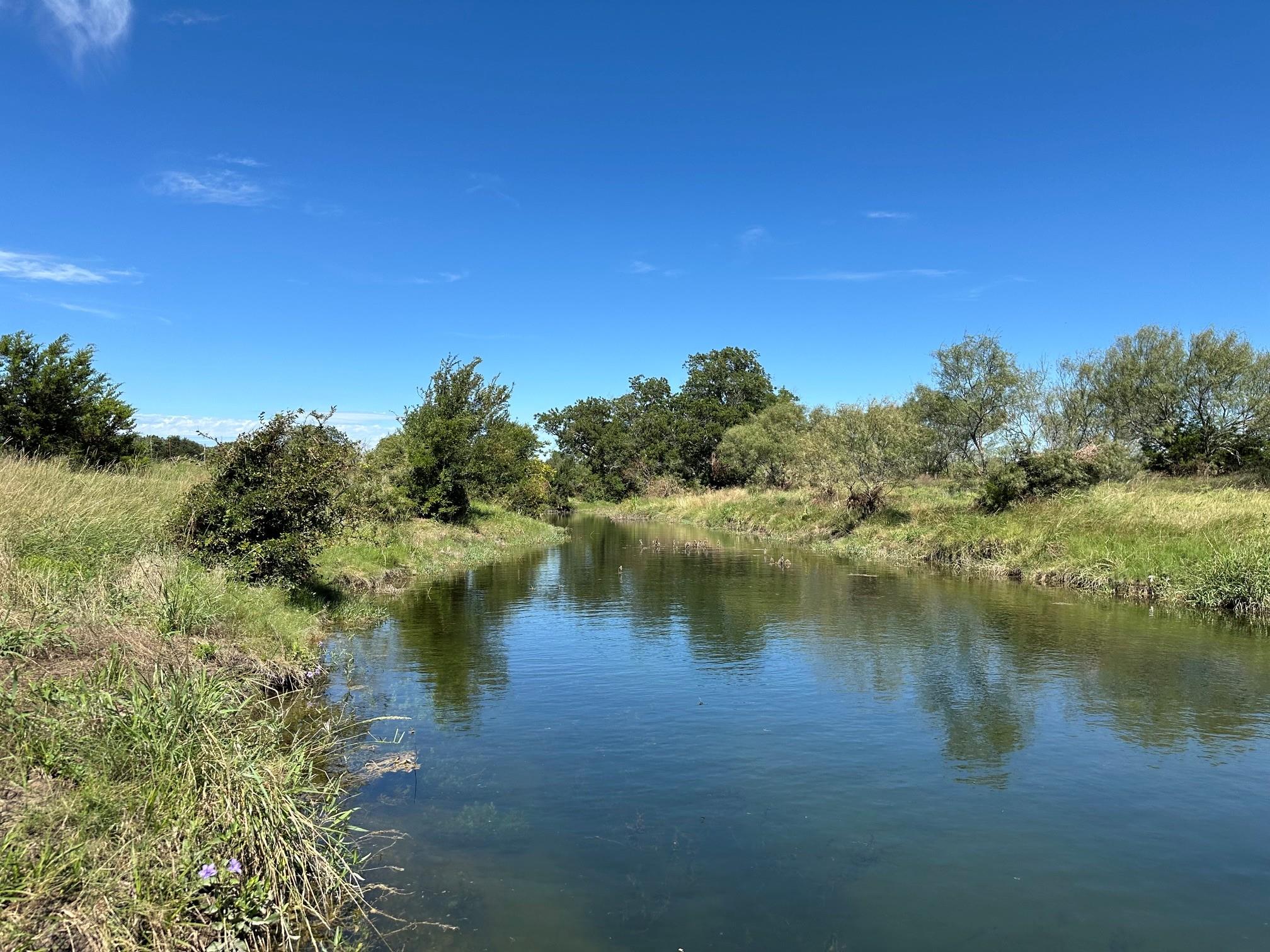 Natural waterway with clear water, surrounded by 