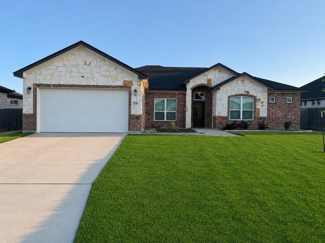 Brick and stone veneer exterior featuring a two-c