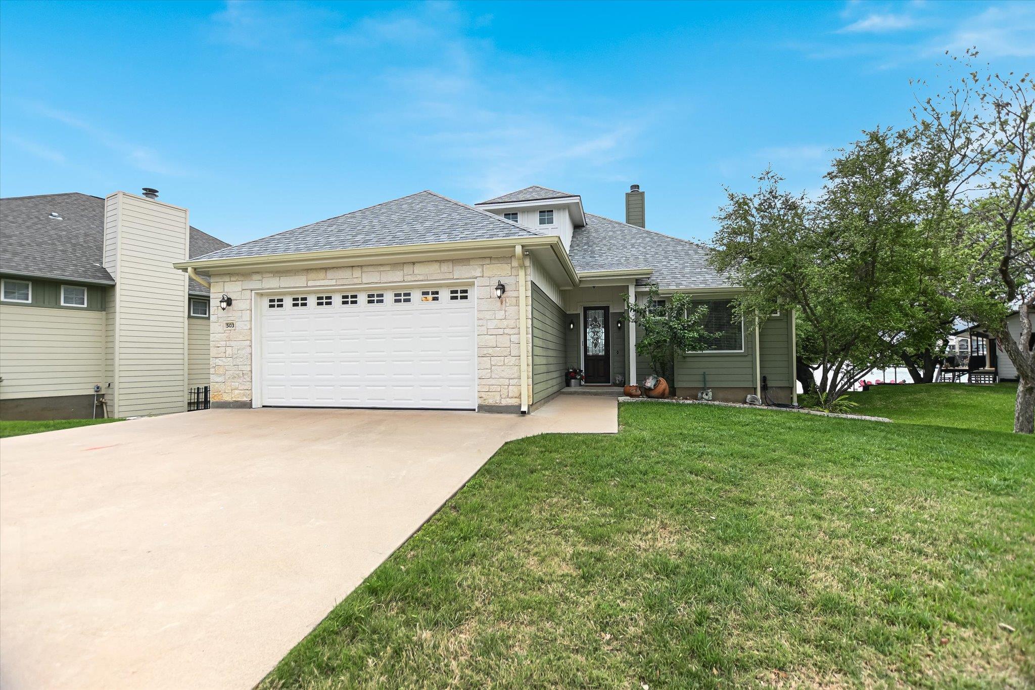 A welcoming residence featuring stone and siding,