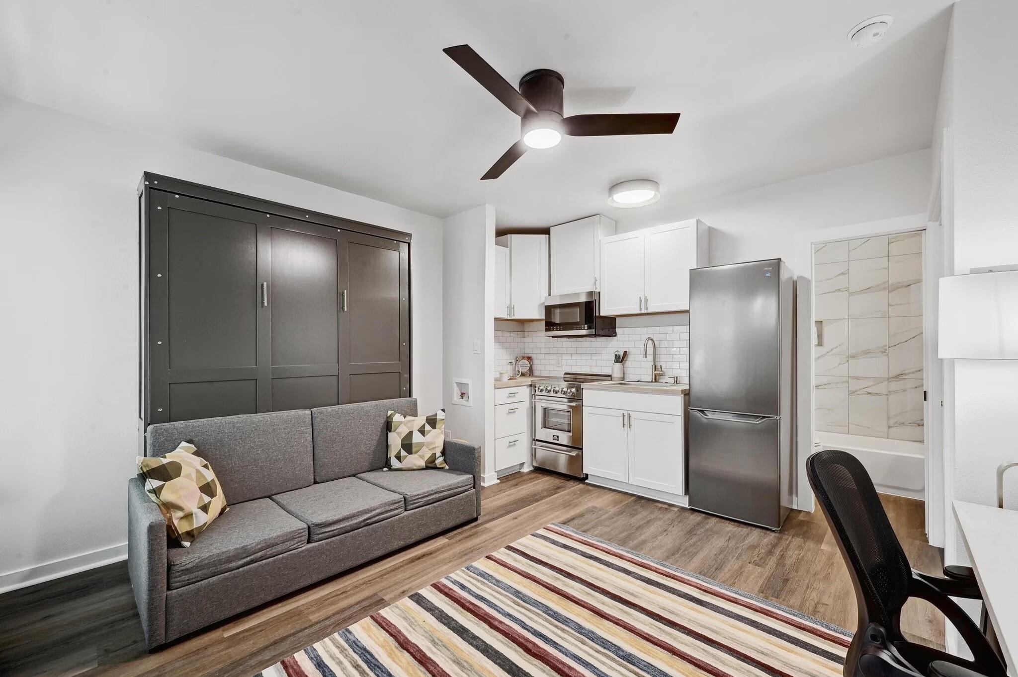 Open-concept living area featuring wood-finish fl
