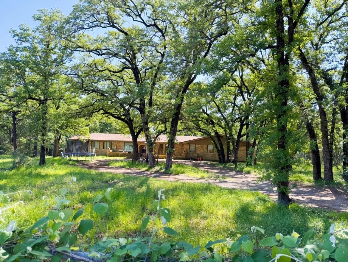 Expansive property featuring a brick exterior hom