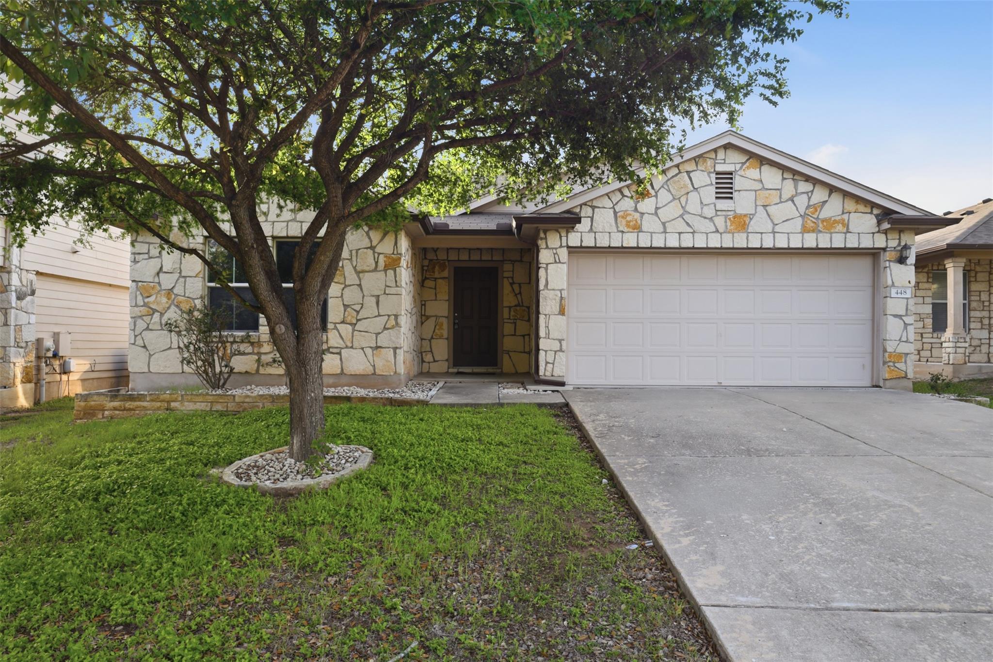 Stone veneer exterior with a two-car garage