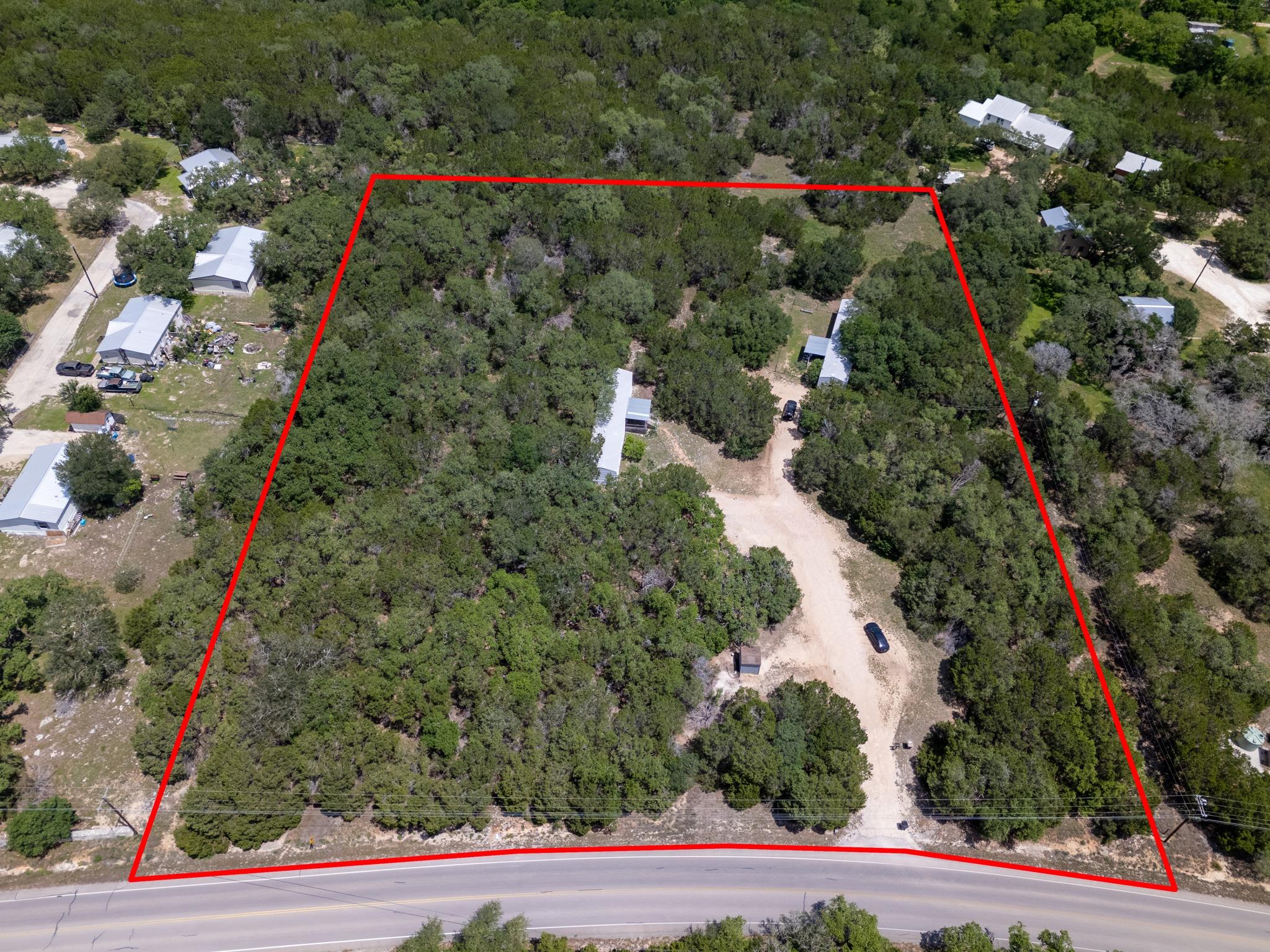 Expansive treed lot featuring multiple structures