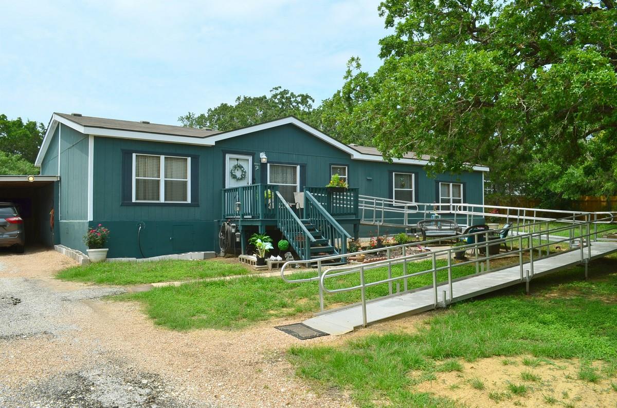 Exterior with teal siding and white trim, featuri