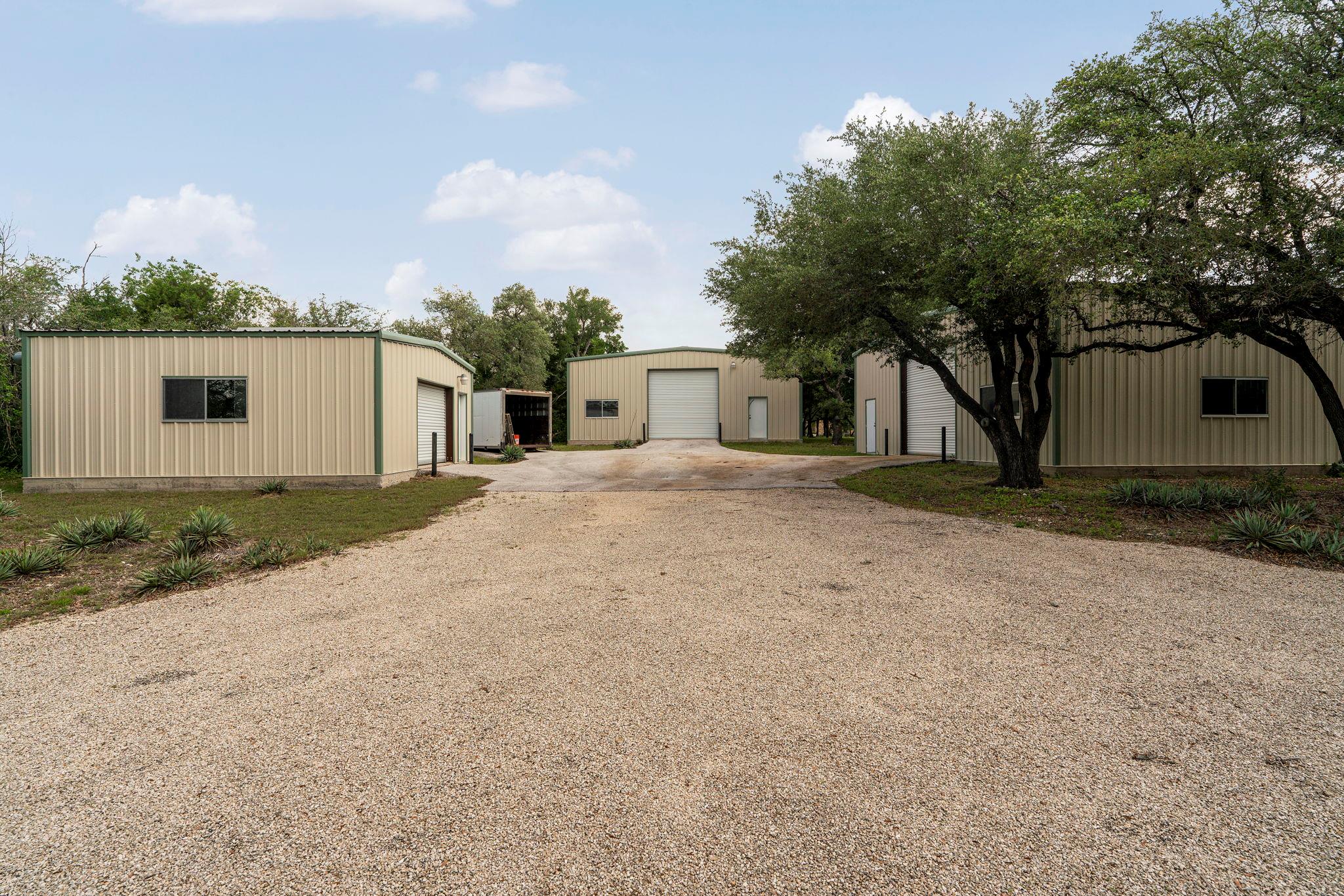 Expansive gravel driveway providing access to mul