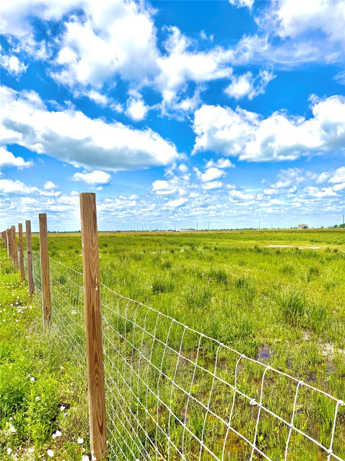 Expansive green landscape featuring a perimeter f