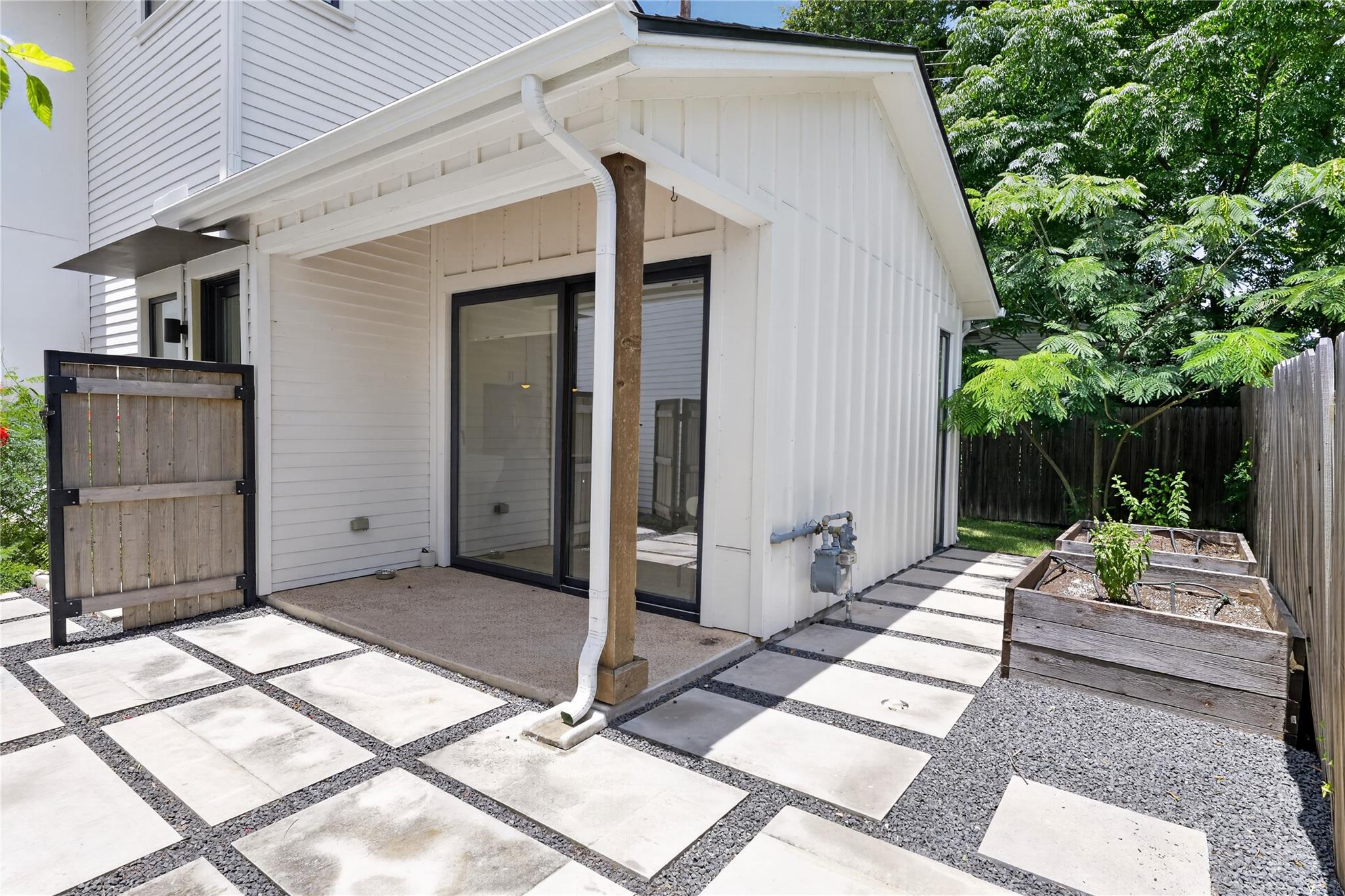 An inviting private courtyard features stylish pa