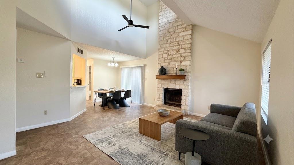 A striking stone fireplace anchors this living sp
