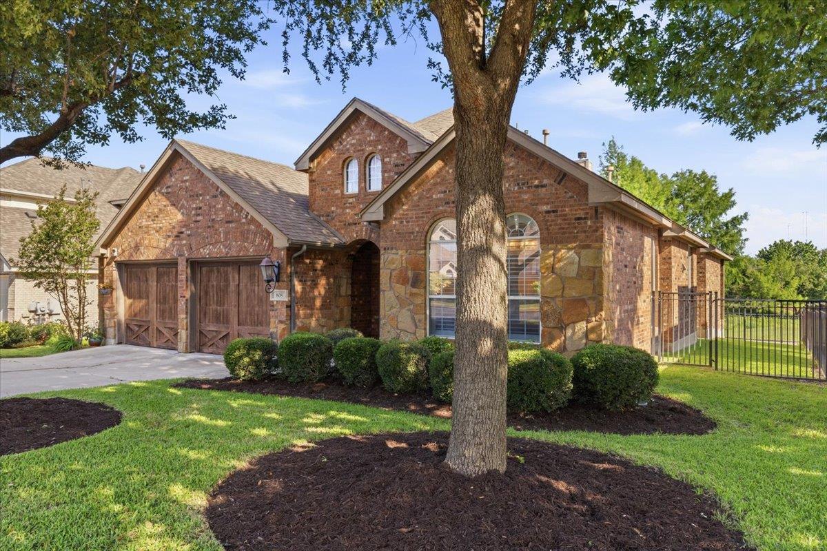 Brick and stone facade featuring arched windows a