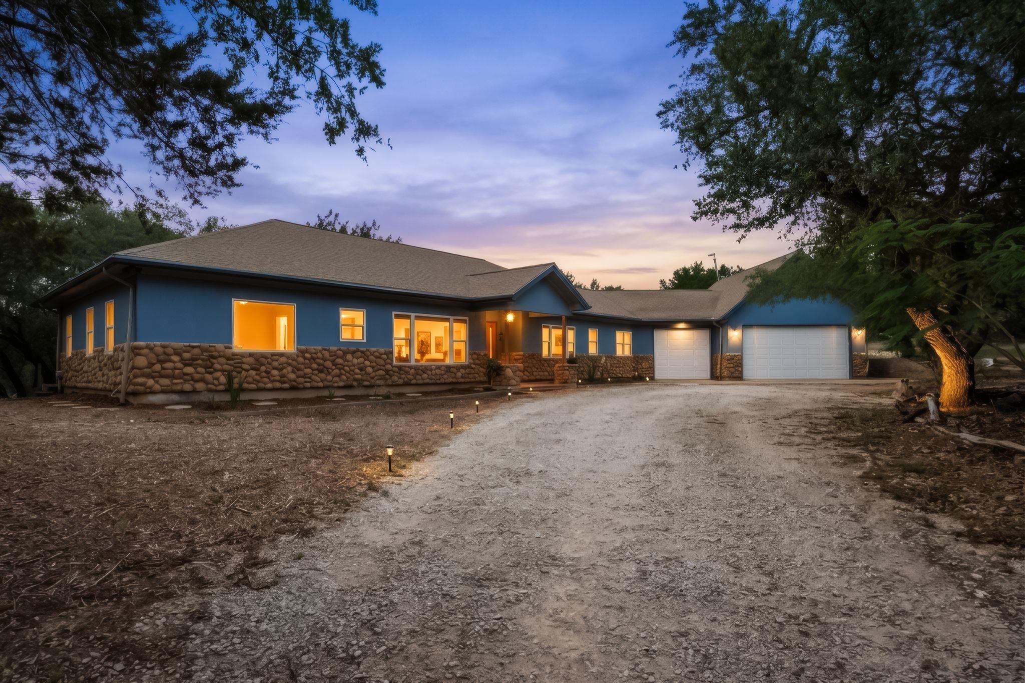 Ranch-style exterior with a blue facade and a nat