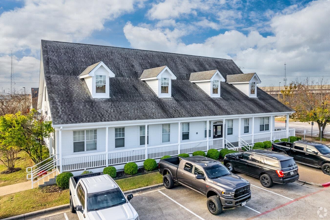 Gabled roofline with multiple dormer windows, a f