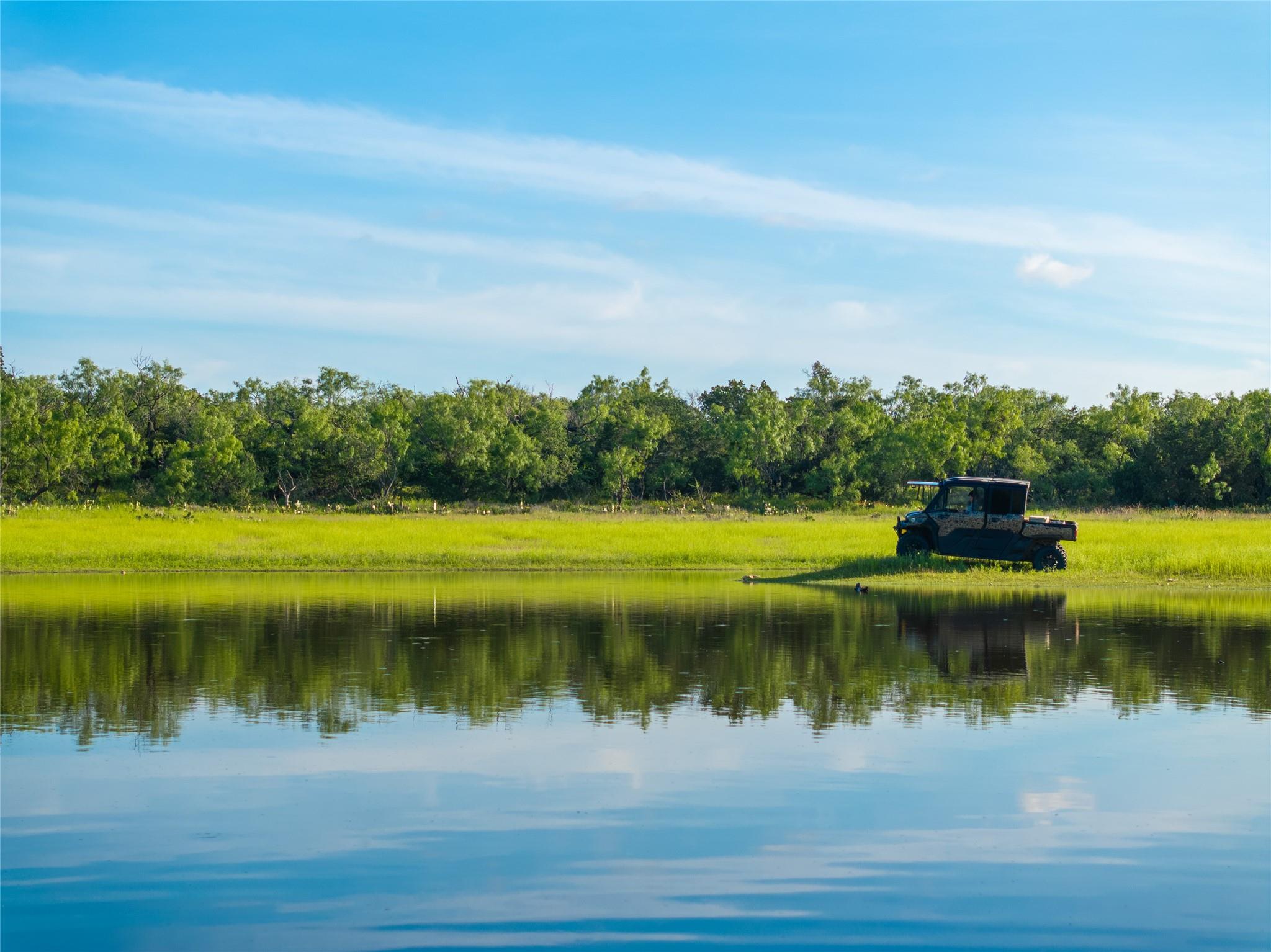 Waterfront property featuring a grassy bank, dens